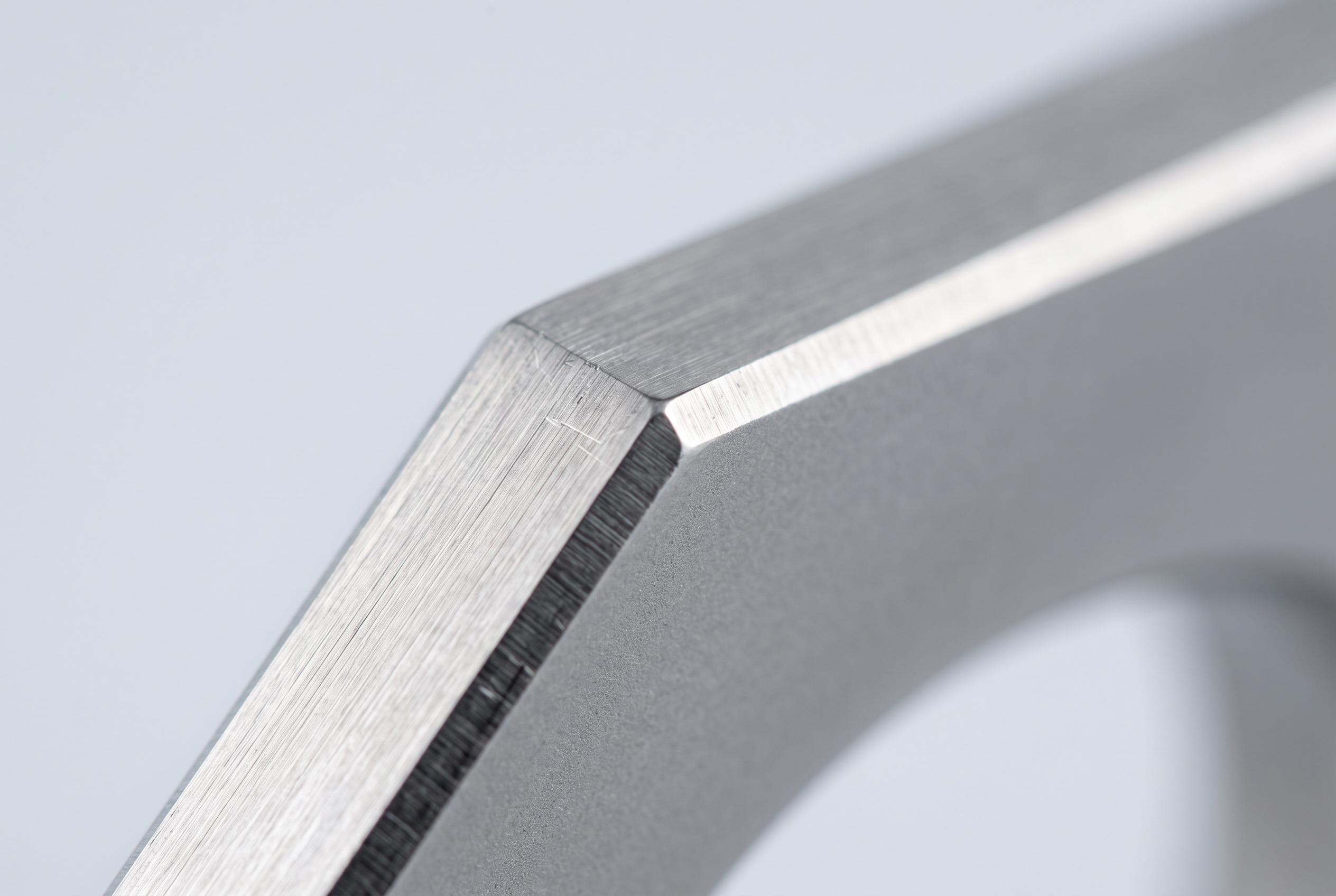 Macro view of a brushed-steel chamfered edge with satin coating